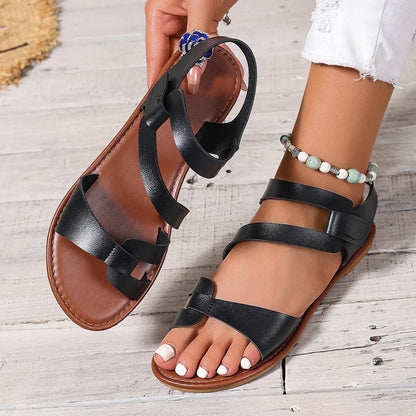 Women's flat sandals with velcro fastening and rubber soles in black, brown and colourful designs