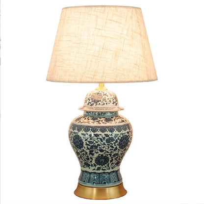Chinese blue and white porcelain table lamp with cloth shade on bedside table