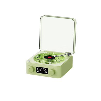Retro-style turntable Bluetooth speaker with glowing RGB light projection on a wooden surface.