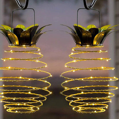 Solar-powered pineapple-shaped outdoor lights with a weather-resistant metal frame and warm white LED bulbs