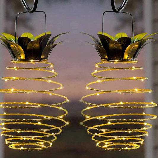 Solar-powered pineapple-shaped outdoor lights with a weather-resistant metal frame and warm white LED bulbs