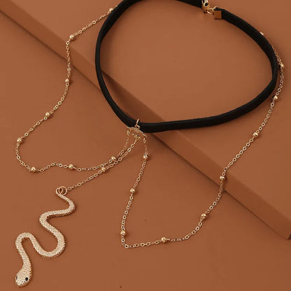Gold colour alloy thigh chain with big snake pendant and beaded geometric leg chain design