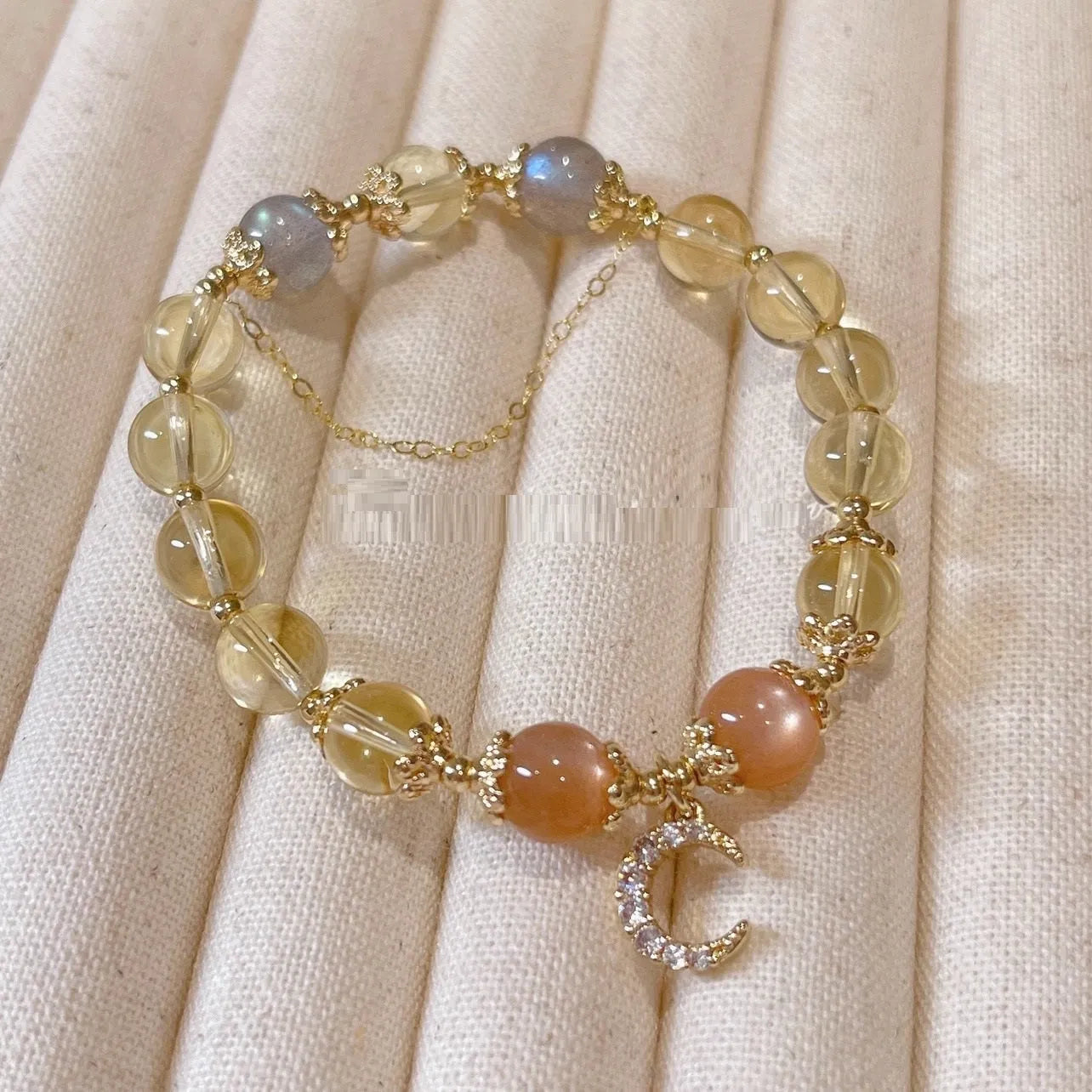 Women's gold electroplated crystal bracelet with moonstone and sunstone stones in Chinese style design.