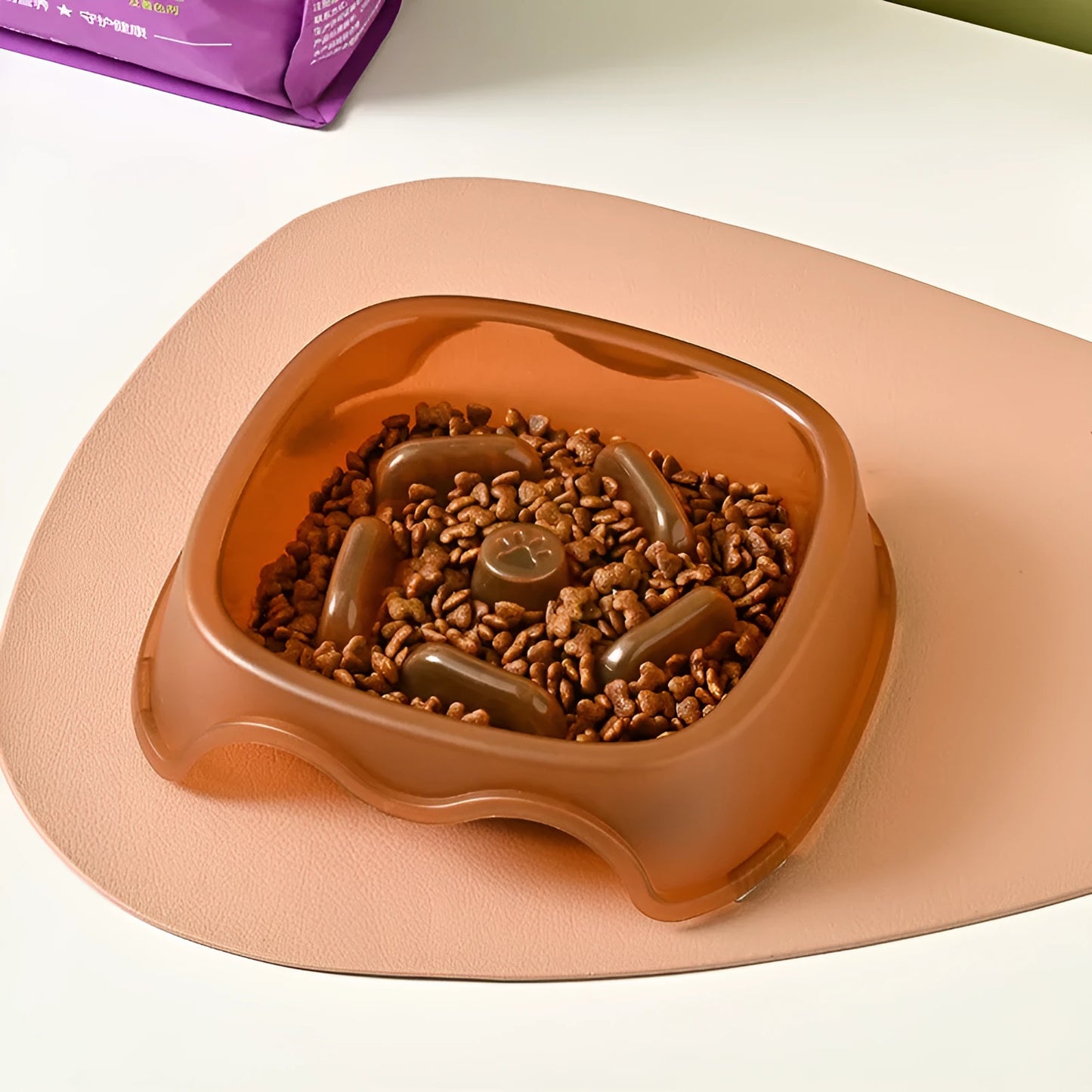 Blue plastic anti-choke slow feeder bowl for dogs on a floor