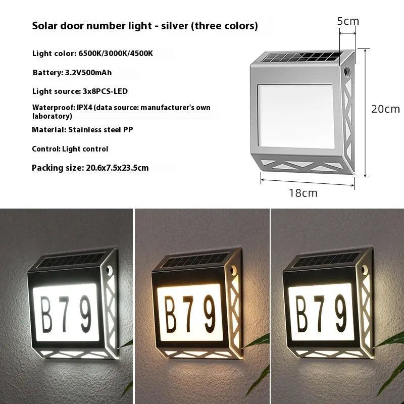 Black solar doorplate light with LED illumination showing house numbers