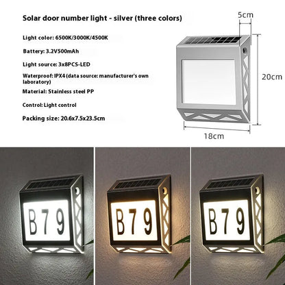 Black solar doorplate light with LED illumination showing house numbers