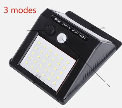Solar-powered outdoor garden lamp with motion sensor mounted on wooden post