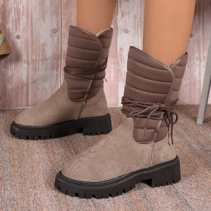 Women's black suede snow boots with chunky heel, fleece lining, and lace-up design for winter wear