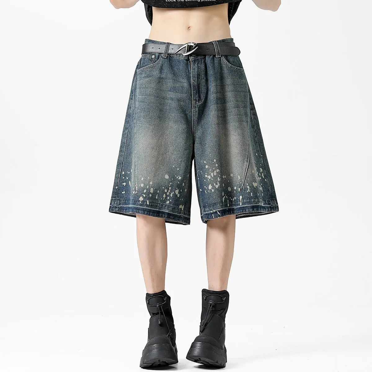 Men's retro blue denim shorts with ripped knees and splash ink detailing, straight leg mid-thigh cut.