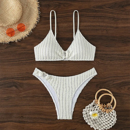 Women's white V-neck two-piece swimsuit with sleeveless top and matching shorts