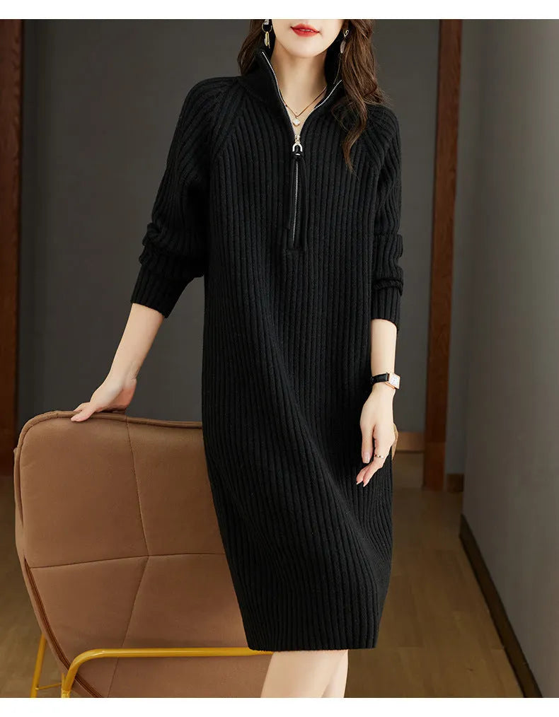 Beige half-zip woolen skirt with long sleeves, a stand collar, and a loose, straight midi silhouette.