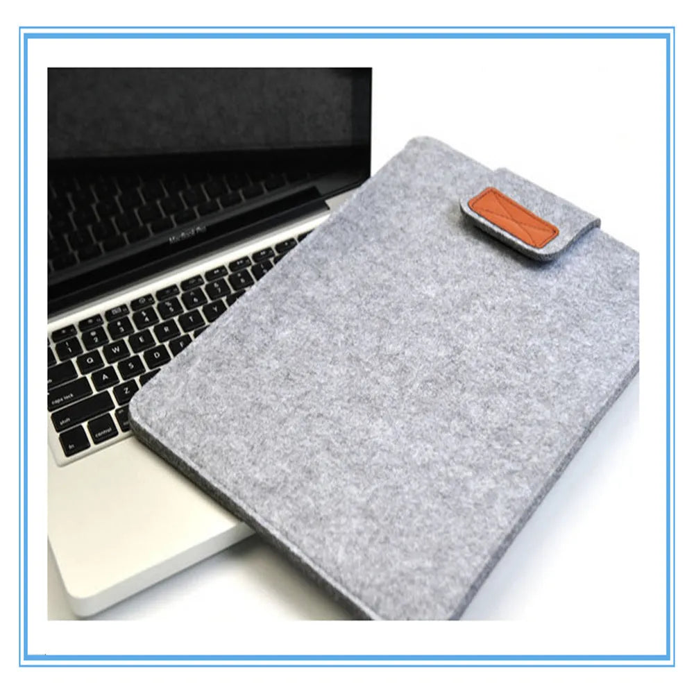Dark grey clamshell laptop bag open to show plush internal liner and corner protectors.