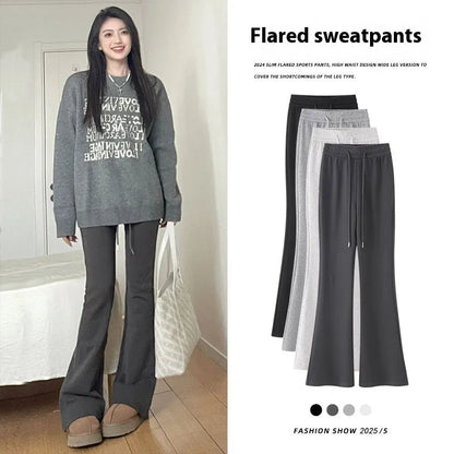 Women's high waist bootcut sports pants in black cotton with fleece lining and micro elasticity, slightly flared leg.