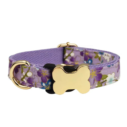 Flat nylon grid print dog collar with a white plastic bone-shaped buckle on a green background.