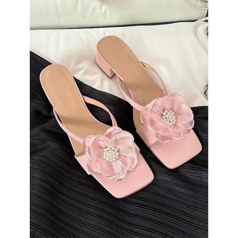 Women's cream-white sandals with chunky heel, square toe, one-line strap, and a decorative flower on the satin upper.
