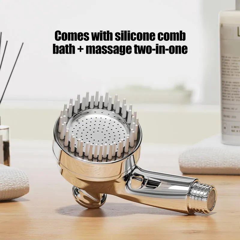 Silver dog shower attachment with integrated silicone comb and rubber grip handles.
