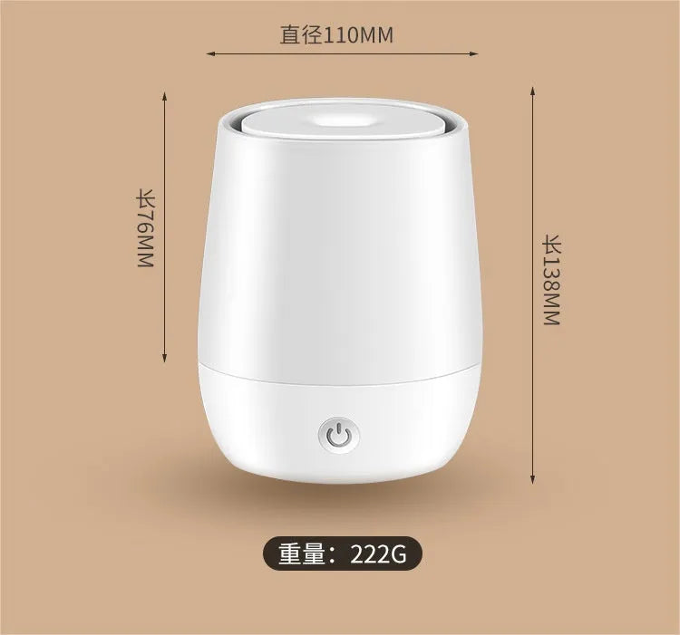 White USB aroma diffuser with simulated flame lighting effect on a wooden surface.