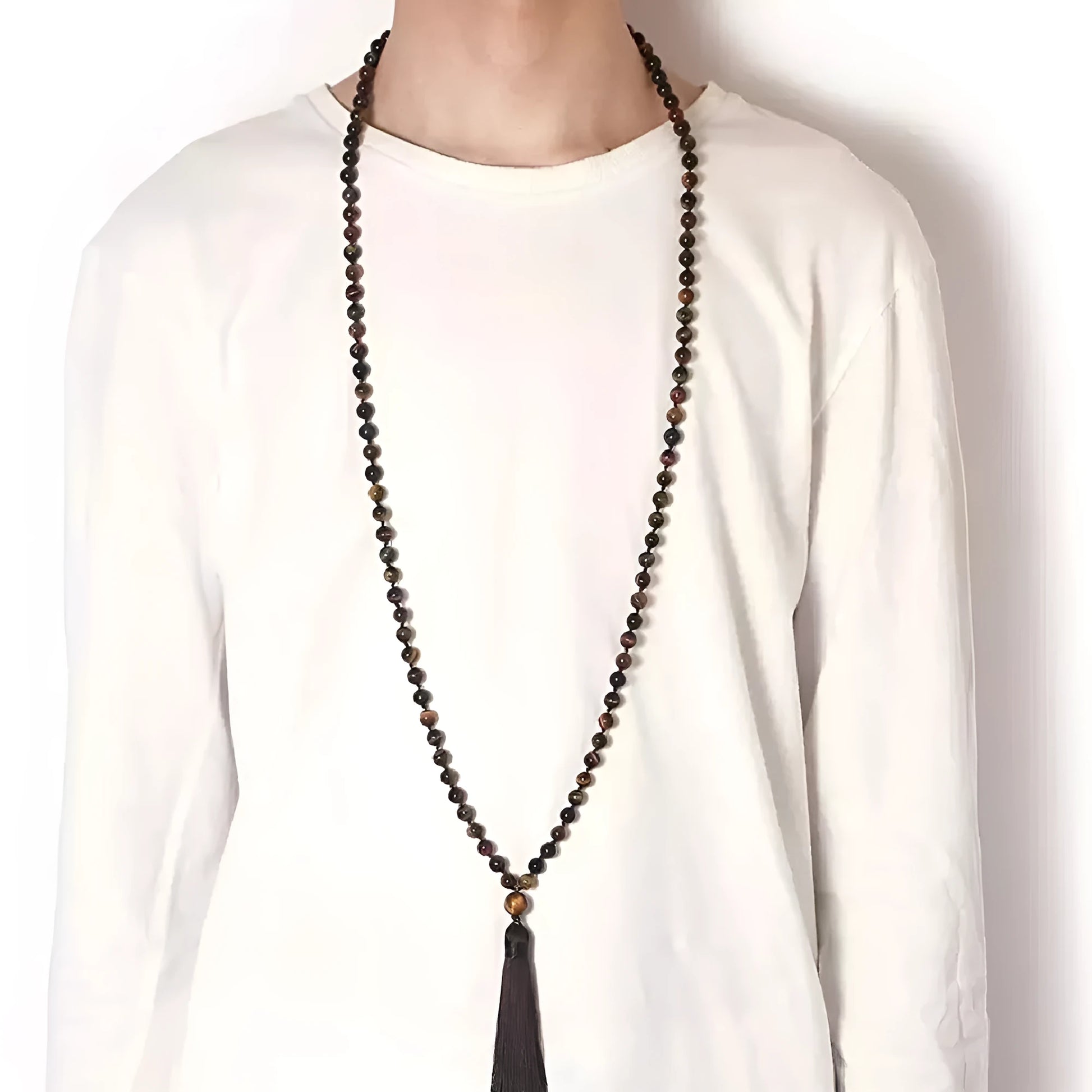 Long multi-coloured agate and stone tassel necklace with geometric beads on a white background.