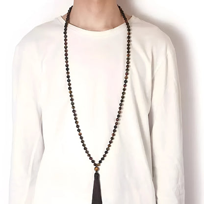 Long multi-coloured agate and stone tassel necklace with geometric beads on a white background.