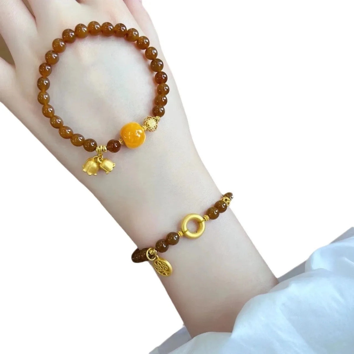 Caramel-coloured women's bracelet with beeswax Lily, music note, and blessing charms in New Chinese style.