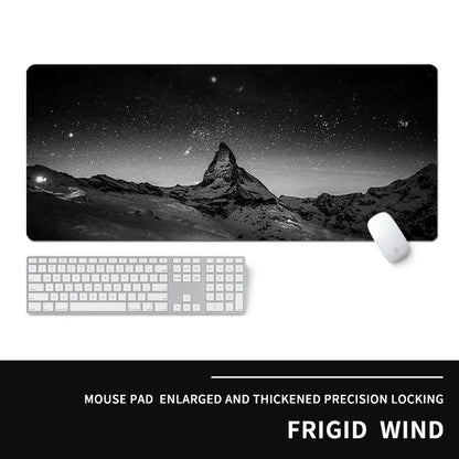 Oversized rectangular mouse pad with a printed design on a desk, next to a keyboard and mouse.