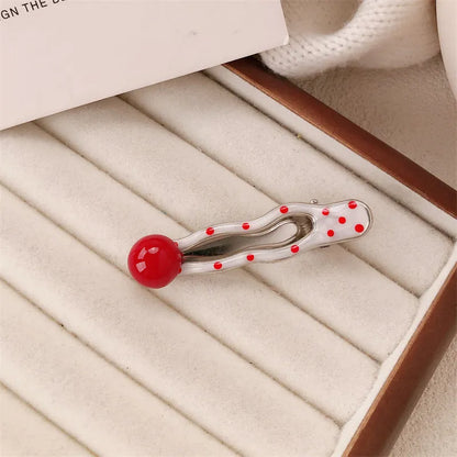 Red love heart-shaped hair barrette clip with retro white dots on a willow leaf-shaped base.