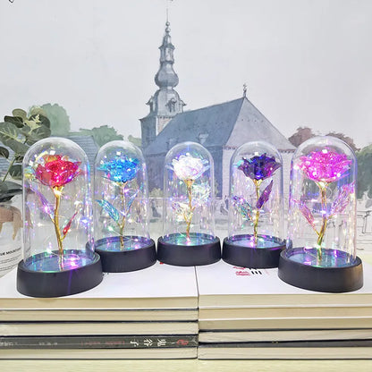 Glass cover small night lamp with plastic flowers, 15cm height, black base, showing colour light options