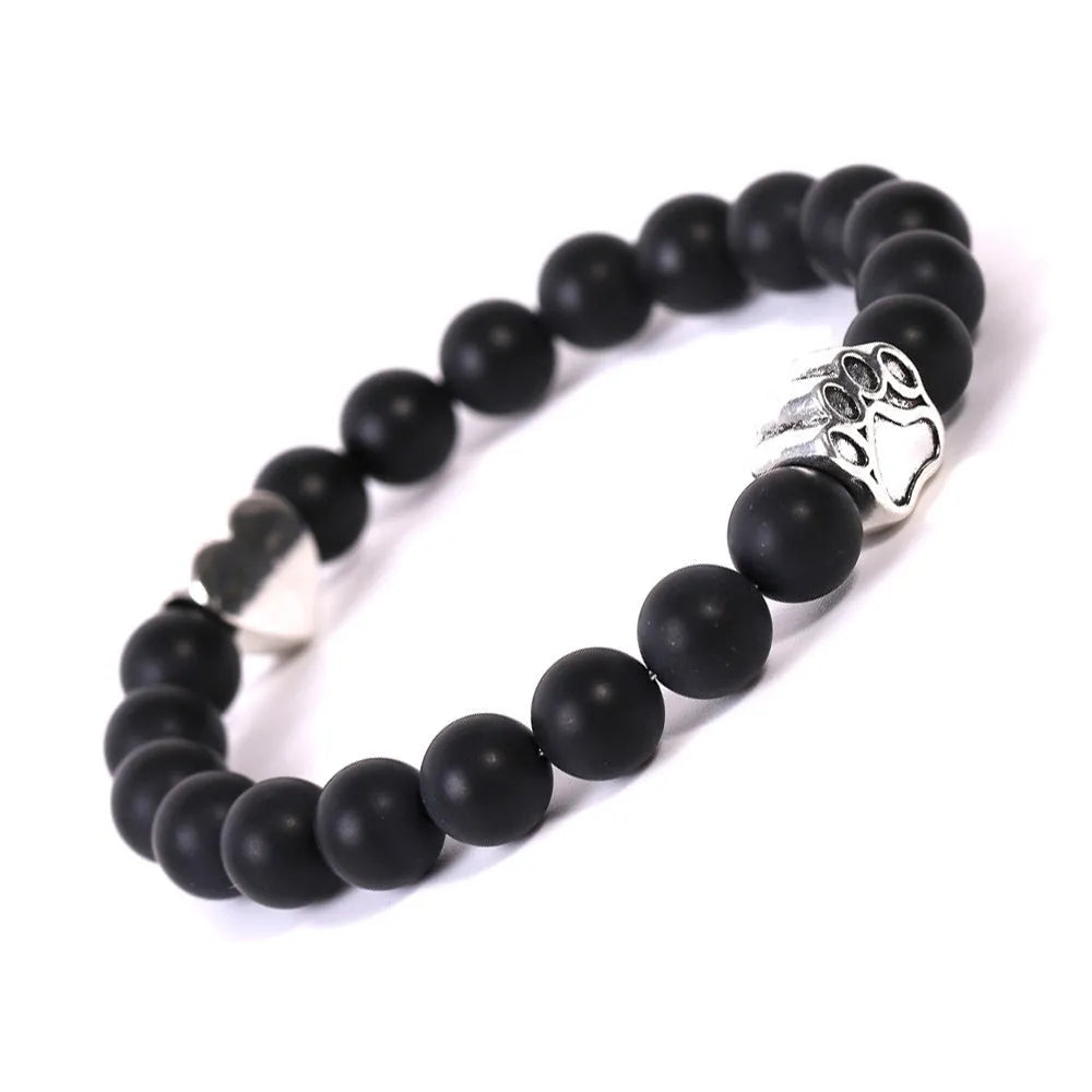 Tiger's eye stone bracelet with dog paw and Indian agate beaded designs on a wrist.