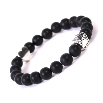 Tiger's eye stone bracelet with dog paw and Indian agate beaded designs on a wrist.