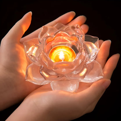 Glass lotus-shaped aromatherapy candle cup on a table.