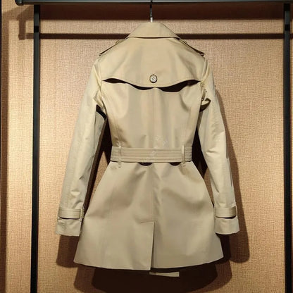 Khaki women's double-breasted trench coat with flight sleeves on a hanger.