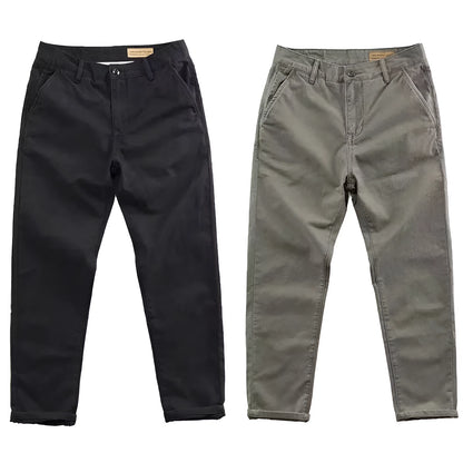Man wearing slim fit grey micro elastic washed trousers with a straight leg cut for a business casual look.