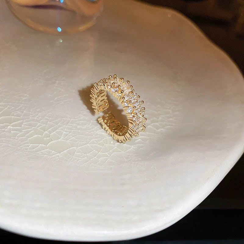 Elegant square ring with hollowed-out design and shimmering zircon stones, perfect for the stylish British woman