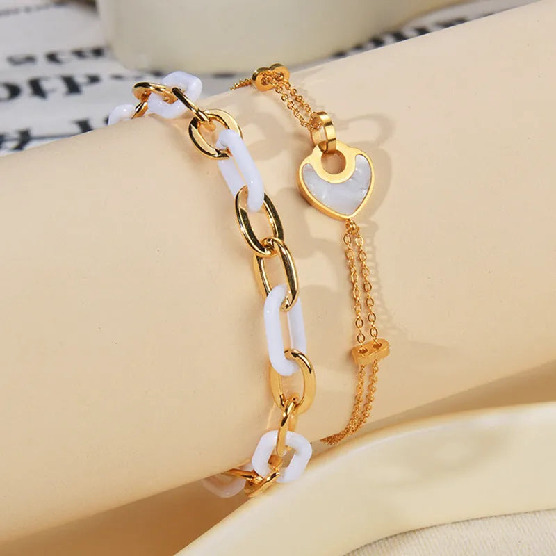 Women's stainless steel bracelet with double-layered heart design and resin accents, showing adjustable clasp and electroplated finish