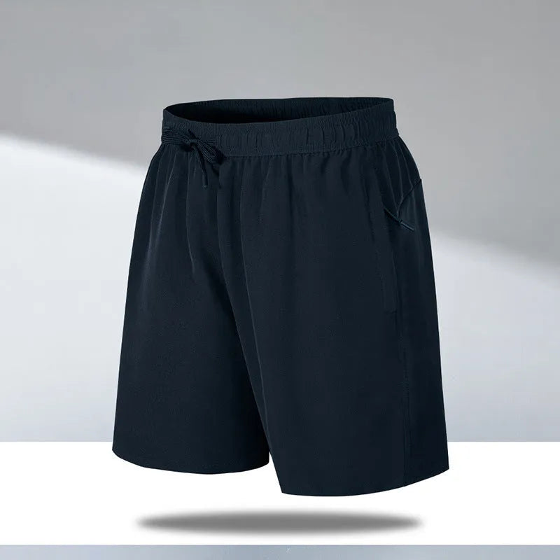 Man wearing black loose-fit quick-dry polyester sports shorts on a summer day.
