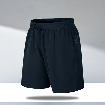 Man wearing black loose-fit quick-dry polyester sports shorts on a summer day.