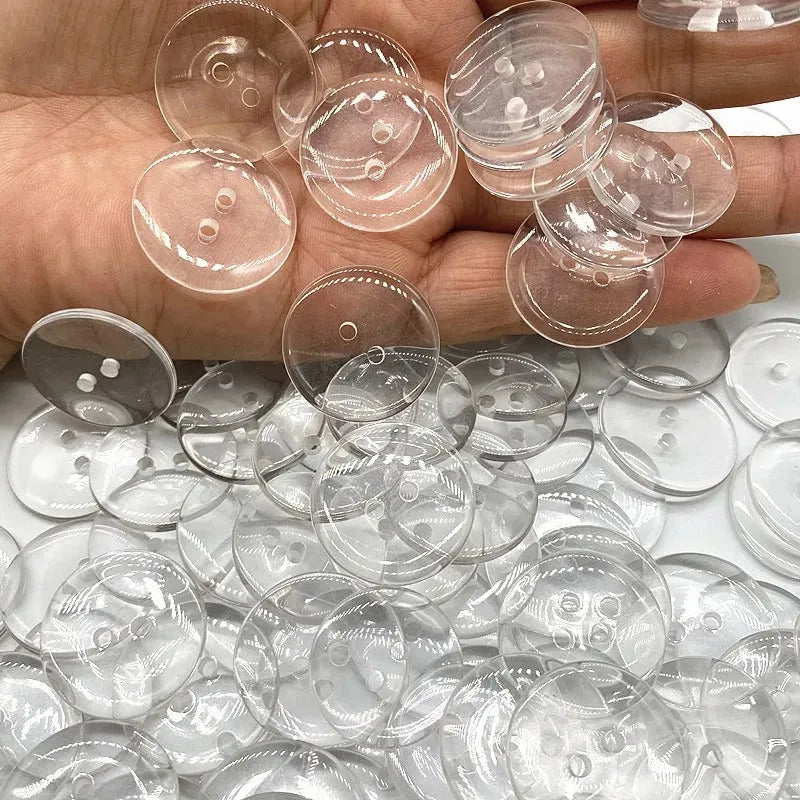 Transparent plastic resin sewing buttons with two holes, 10mm in diameter.