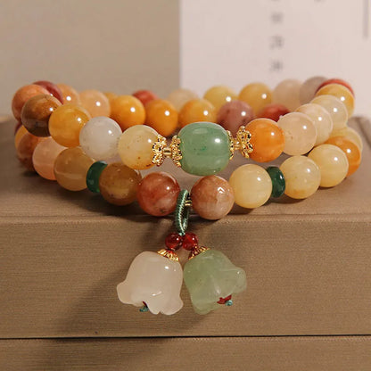 Natural green jade multi-strand bracelet with a silver-ton orchid charm for women.