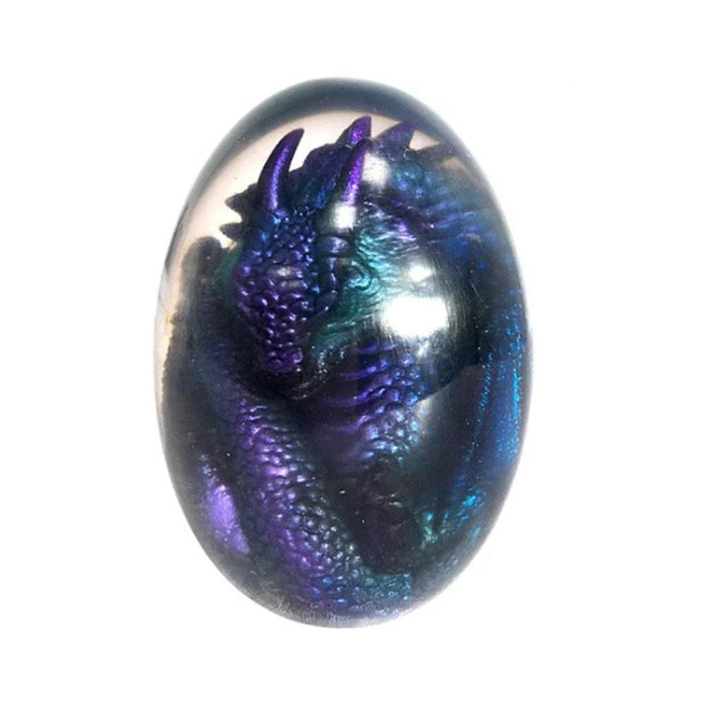 A lifelike resin dragon egg ornament with a crystal-clear, transparent design, sitting on a glowing lava-style base.