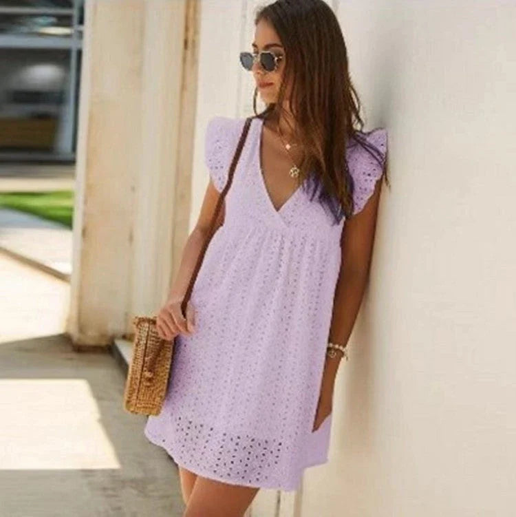 Chic cotton mini dress with floral embroidery and v-neck design for a romantic, summer-ready look