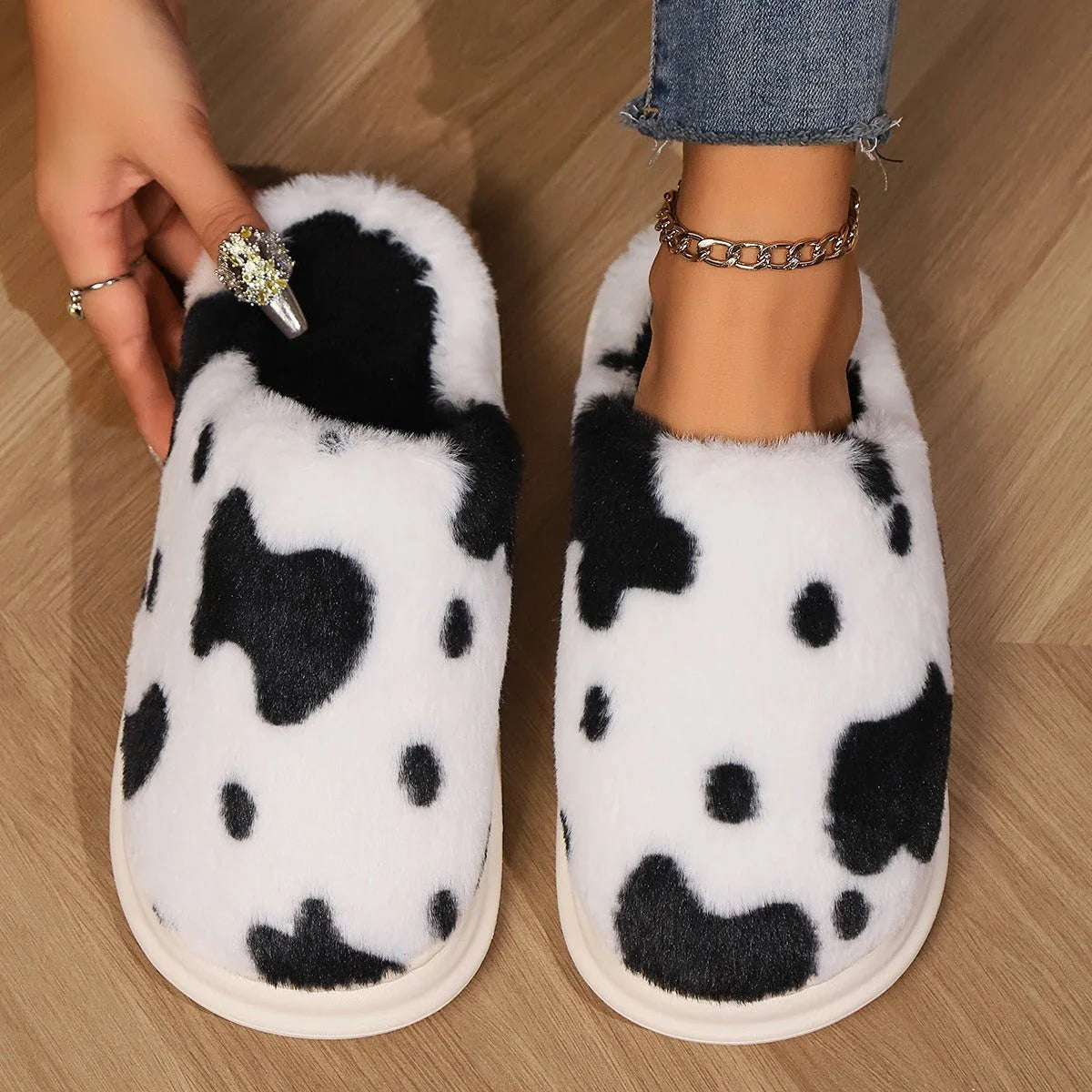 Cozy cow print plush slippers with soft, cushioned soles and non-slip outsoles for indoor comfort and warmth
