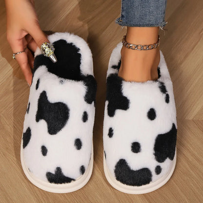 Cozy cow print plush slippers with soft, cushioned soles and non-slip outsoles for indoor comfort and warmth