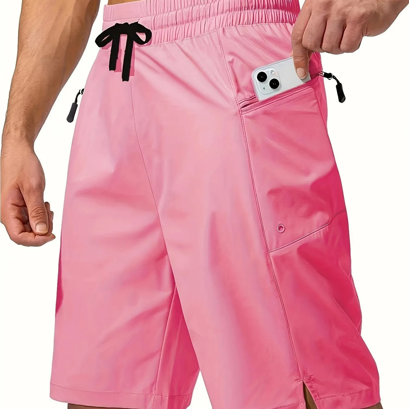 Man wearing solid colour straight-leg beach shorts in quick-dry polyester fabric.