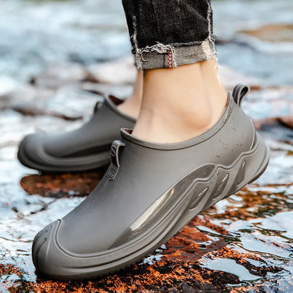 Men's short casual rain boot in solid colour, plastic upper, shown on foot.