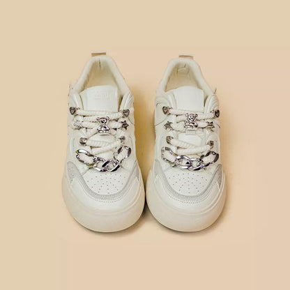 Women's white low-top sneakers with rubber sole and lace-up closure