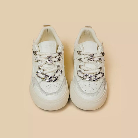 Women's white low-top sneakers with rubber sole and lace-up closure
