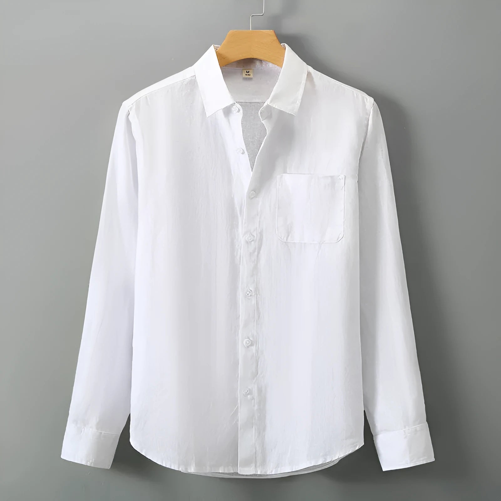 Man wearing a loose-fit light grey long sleeve linen cardigan shirt with a Chinese style design.