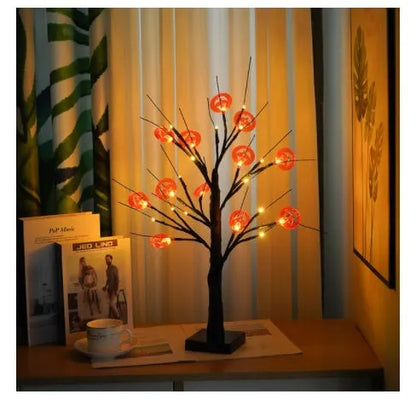 60cm tall white LED birch tree night light on a table, available in black, pumpkin, bat, or maple designs.