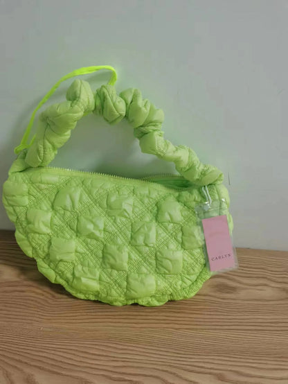 Women's light grey nylon underarm messenger bag with adjustable long strap, shown worn crossbody.