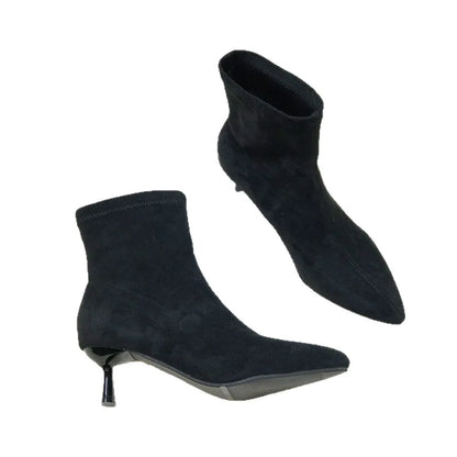 Women's black pointed toe ankle boots with a stiletto heel on a neutral background